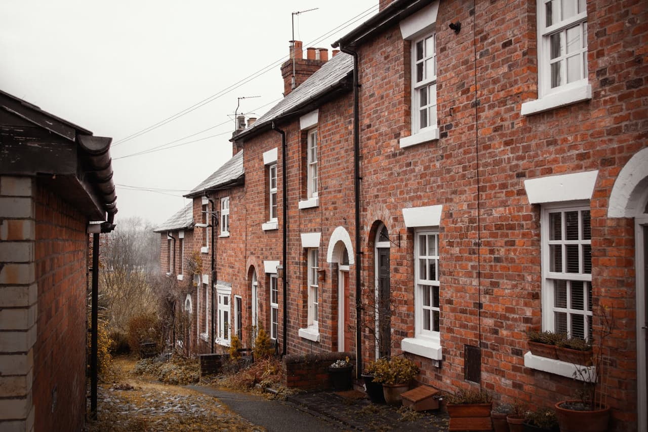 Picturesque view of traditional brick houses lining a quaint alley in Shrewsbury, England.